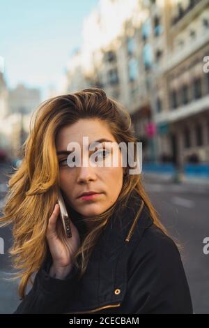 Woman using smartphone on road Stock Photo