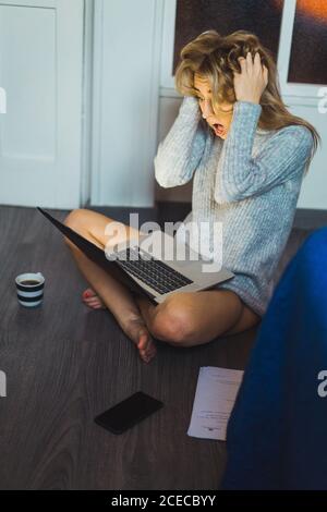 Shocked scared Woman at laptop Stock Photo