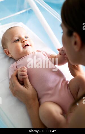 Beautiful mother and her newborn baby together. Love, happiness, family concept. Stock Photo