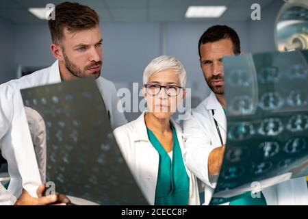 Group of doctor looking at ct scan at hospital to make diagnosis Stock Photo