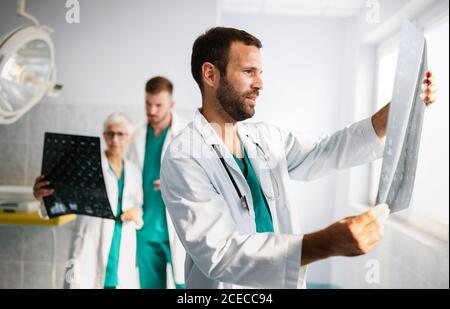 Portrait of young doctor checking X-Ray in hospital to make diagnosis Stock Photo
