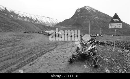 Snowmobile in Longyearbyen on the island Spitsbergen waiting for the winter and the snow. Black and White picture on Svalbard. Stock Photo