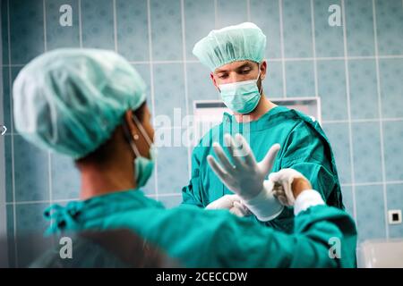 Team of surgeons in the operating room preparing for surgery Stock Photo