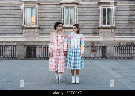 Two young women with theatrical makeup and unusual clothes performing on city street Stock Photo