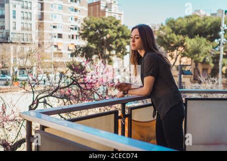 Dreamy Woman standing on balcony Stock Photo