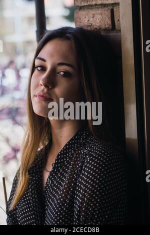 Dreamy Woman standing on balcony Stock Photo