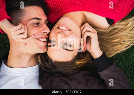 Happy loving couple posing on grass Stock Photo