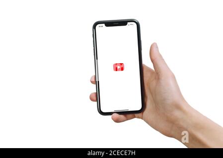 Samara Russia - 04.05.2020: A man holds an iPhone 11 in his hand with the Youtube app on a white isolated background. Welcome page. Stock Photo