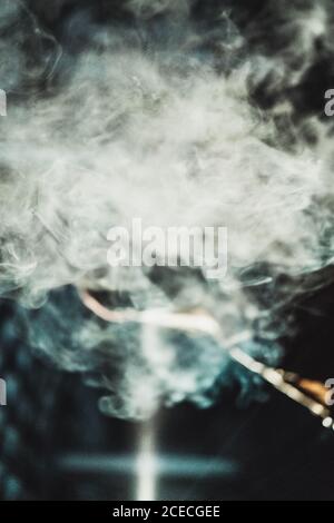 White cloud of smoke puffed in dark night. Stock Photo