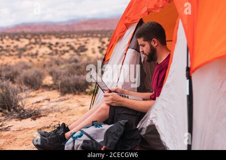 Traveler using laptop into a tent Stock Photo