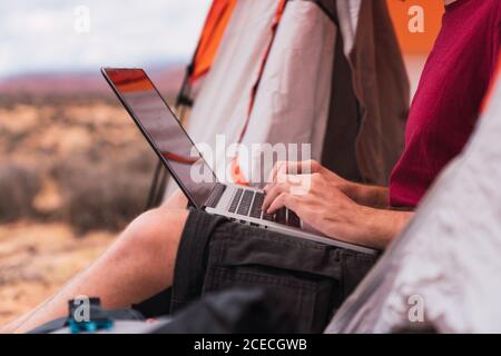 Traveler using laptop into a tent Stock Photo