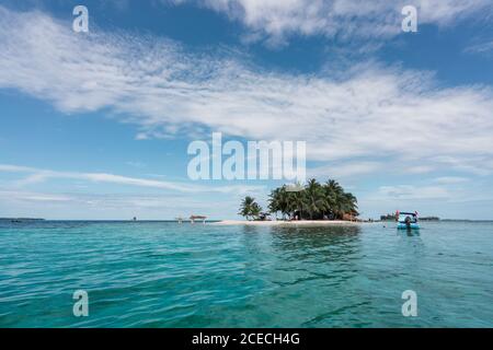 Little island with palms and building between water Stock Photo