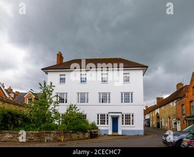 A large white house in High Street, centre of Petworth, a town in West Sussex, southeast England, on an overcast cloudy day Stock Photo