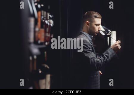 Winemaker sommelier man sniffing aroma red wine in glass Stock Photo