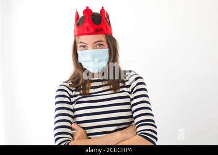 Woman with crown and protective mask Stock Photo