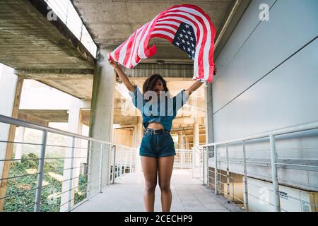 Young Woman holding flag of America Stock Photo