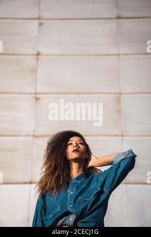 Young Woman standing near building Stock Photo