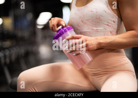 Young sportsWoman drinking water in gym Stock Photo