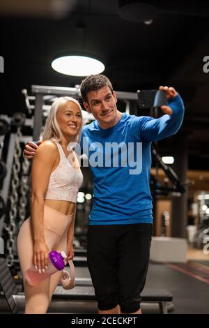 man and Woman doing selfie in gym Stock Photo