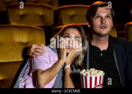 Caucasian man and woman watching a sad movie Stock Photo