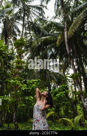 Young lady in dress between tropical forest Stock Photo