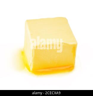 A piece of melting butter isolated on white background. Butter cube. Stock Photo