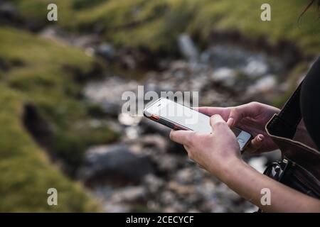 Woman using smartphone in nature Stock Photo