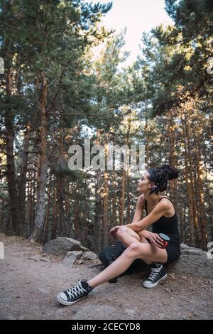 Cheerful charming young woman with backpack walking in park Stock Photo ...