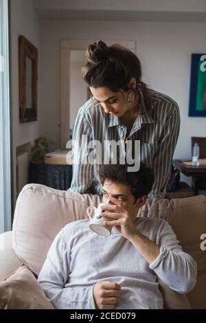 Cheerful couple having fun at couch Stock Photo