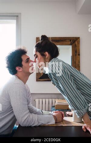 Couple kissing at table Stock Photo