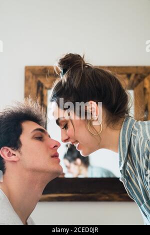 Couple kissing at table Stock Photo