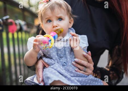 Mother playing with baby in park Stock Photo