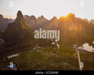 Guangxi fields and town surrounded by mountains Stock Photo