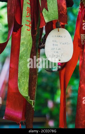 Close-up of colorful stripes of ribbons and love confession paper hanging on tourist place, Yanoda Rainforest, China Stock Photo