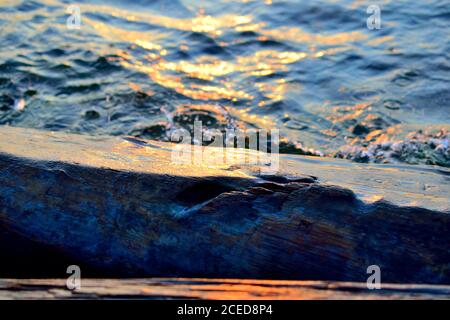 Waves Splashing Against a Log on Olkhon Island, Lake Baikal, Russia Stock Photo