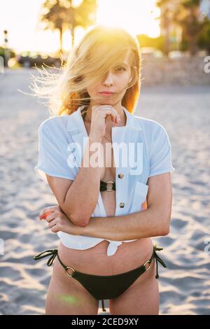 Gorgeous female standing on beach Stock Photo