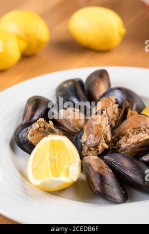 Turkish Delicious Rice Stuffed Mussels serving with lemon. Turkish Midye Dolma. Stock Photo