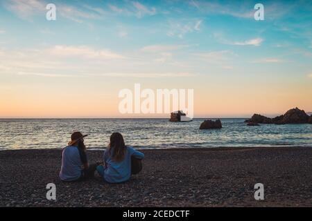 Couple with guitar on beach Stock Photo