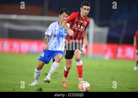 Brazilian football player Oscar dos Santos Emboaba Junior, better known as simply Oscar, of Shanghai SIPG F.C., right, protects the ball during the eighth-round match of 2020 Chinese Super League (CSL) against Tianjin TEDA F.C., Suzhou city, east China's Jiangsu province, 31 August 2020. Shanghai SIPG F.C. defeated Tianjin TEDA F.C. with 4-1. Stock Photo