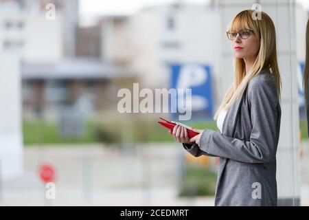 Young attractive Woman standing with tablet Stock Photo