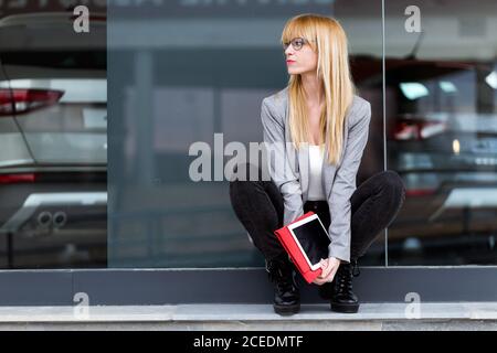 Young attractive Woman sitting with tablet Stock Photo