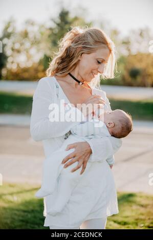 Woman feeding a baby with a bottle Stock Photo