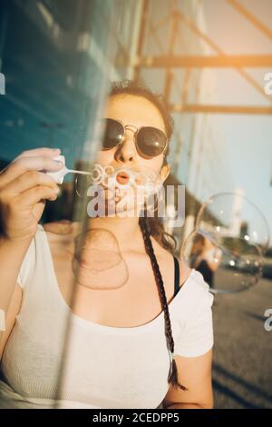 Young Woman blowing bubbles Stock Photo
