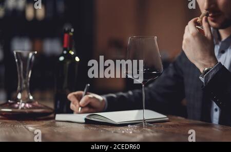 Winemaker sommelier man sniffing aroma red wine in glass Stock Photo