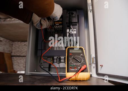 Checking electrical panel and power cable for short circuit Stock Photo