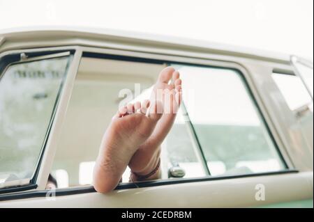 Crop legs in car window Stock Photo