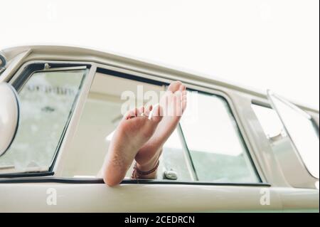 Crop legs in car window Stock Photo