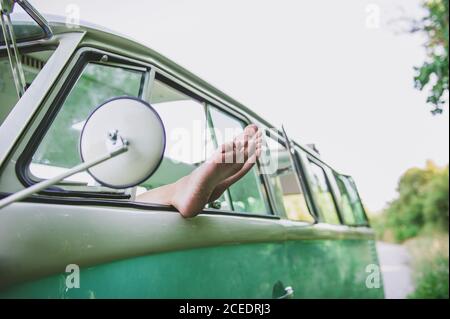 Crop legs in car window Stock Photo