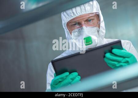Virologist healthcare professional using tablet computer in laboratory, close up of medical worker working, selective focus Stock Photo