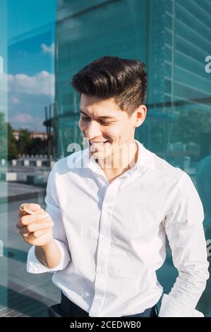 Handsome young man smoking cigarette Stock Photo